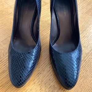 Black matte snakeskin heels. Wooden heel and slightly rounded toe for comfort.